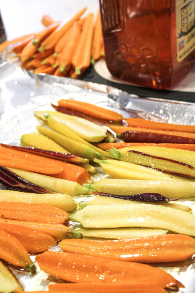 carrots lined up on foil in two rows