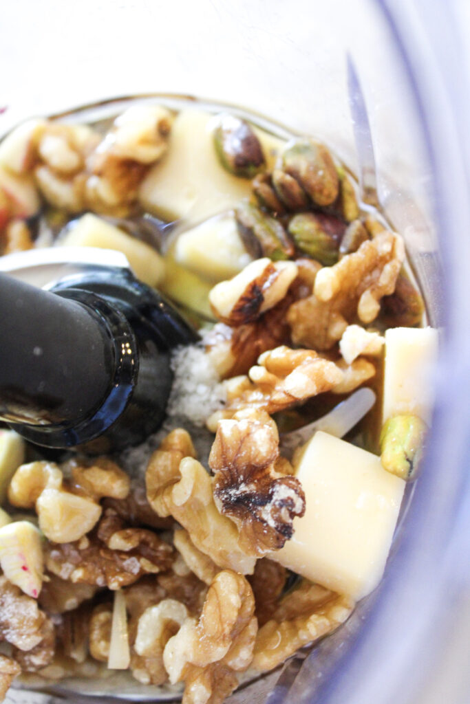walnuts, parmesan and other pesto ingredients in a food processor.