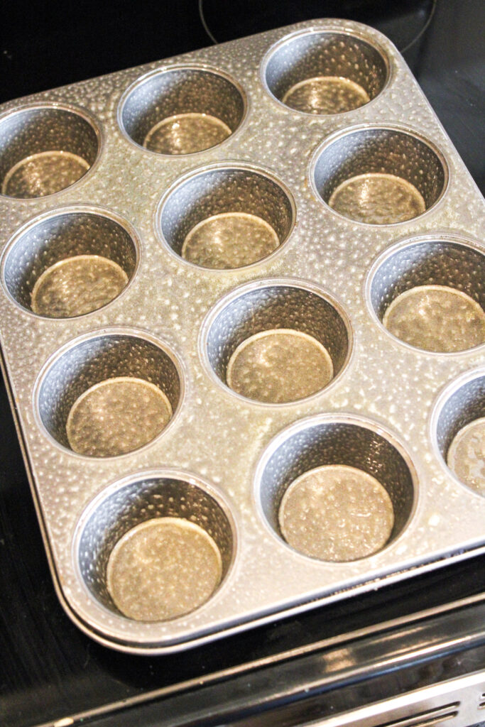a muffin tin sprayed with pam.