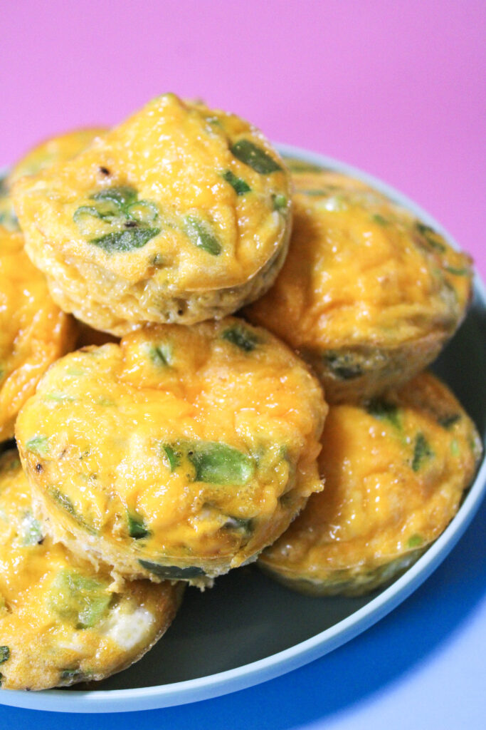Cheddar scallion eggie cups on a blue plate.