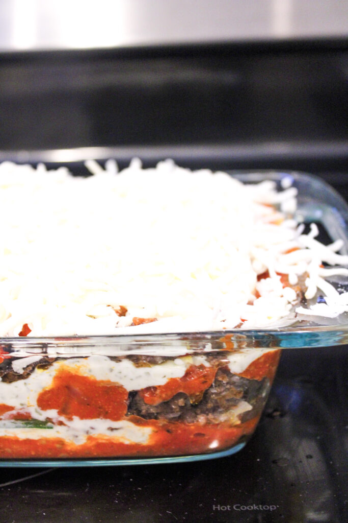 Close up of unbaked lasagna with lots of cheese on top