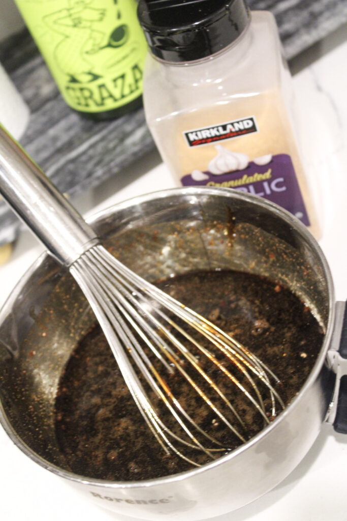 A whisk in the sauce bowl.