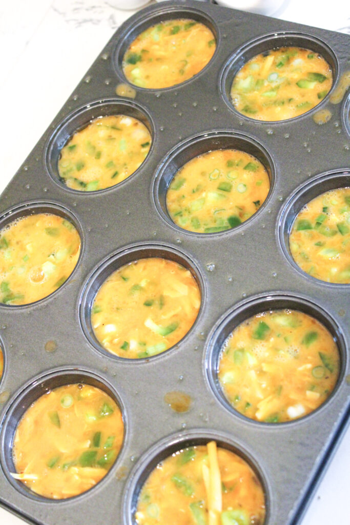 Eggie cup batter unbaked in a muffin pan.