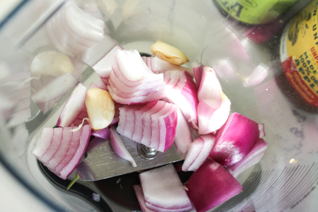 Chopped red onions in a blender.