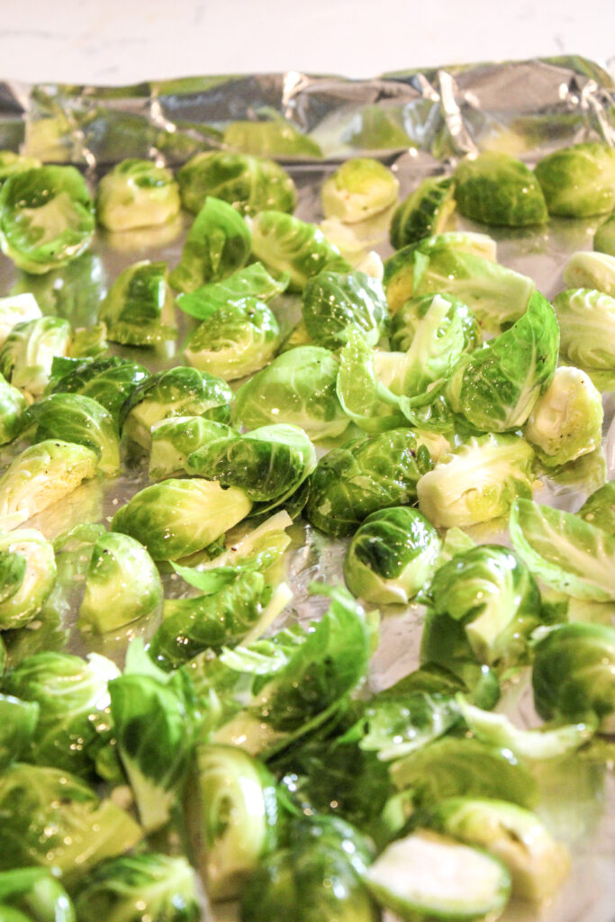 Brussels sprouts on a pan ready for the oven.