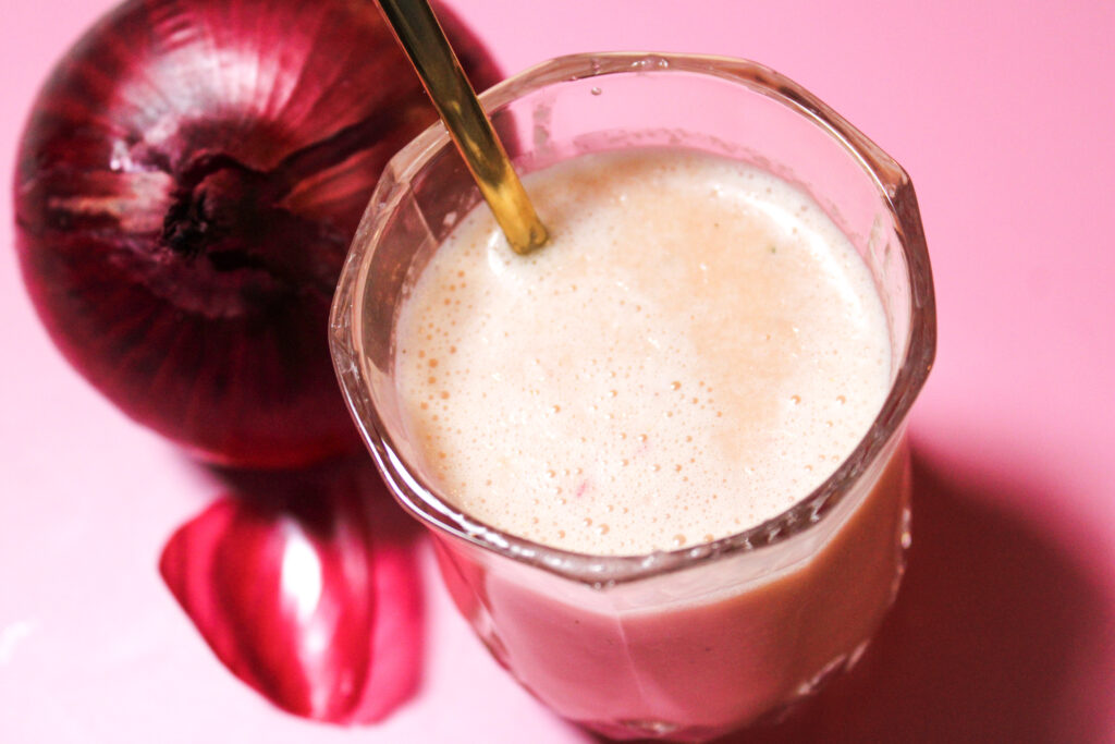 Sweet Red Onion Vinaigrette on a pink backround.