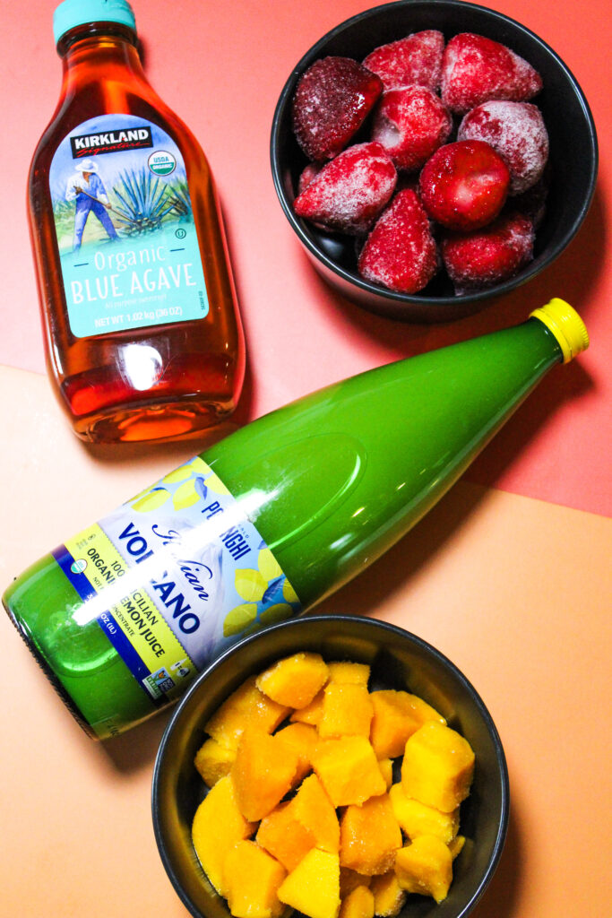Blended Strawberry Mango Lemonade ingredients laid out.