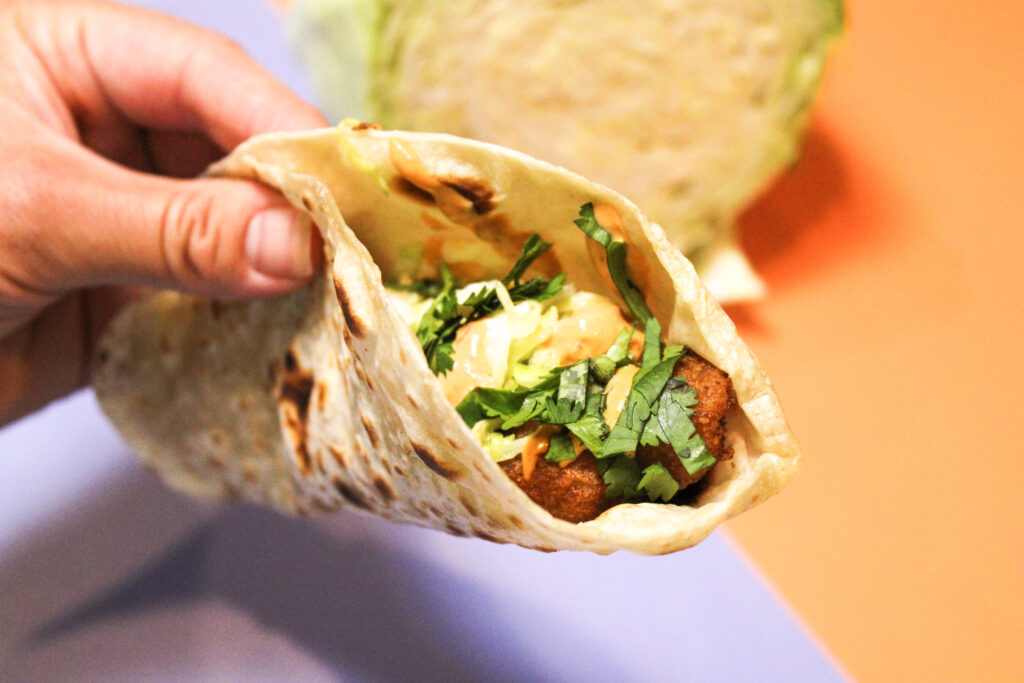 A fish taco with 3 ingredient slaw.