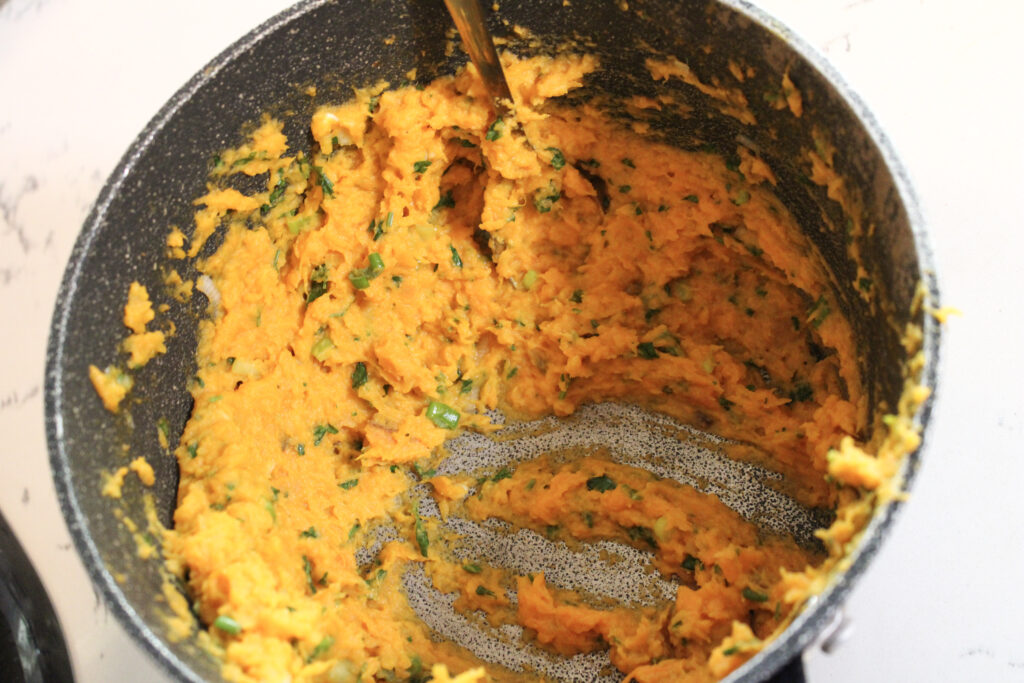 Completed Herby Sweet Potato Mash in a pot.