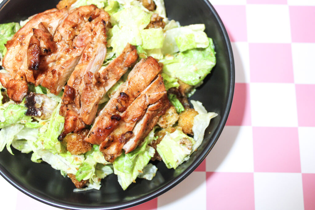 A finished and assembled bbq chicken Caesar salad.